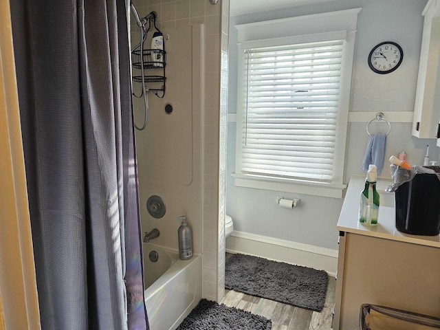 full bathroom with plenty of natural light, shower / bathtub combination with curtain, wood finished floors, and vanity