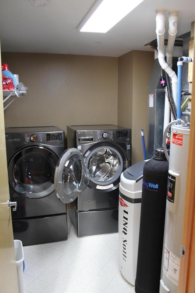 laundry area featuring electric water heater and washer and dryer