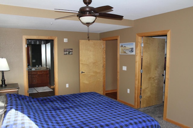 carpeted bedroom with ceiling fan and ensuite bathroom