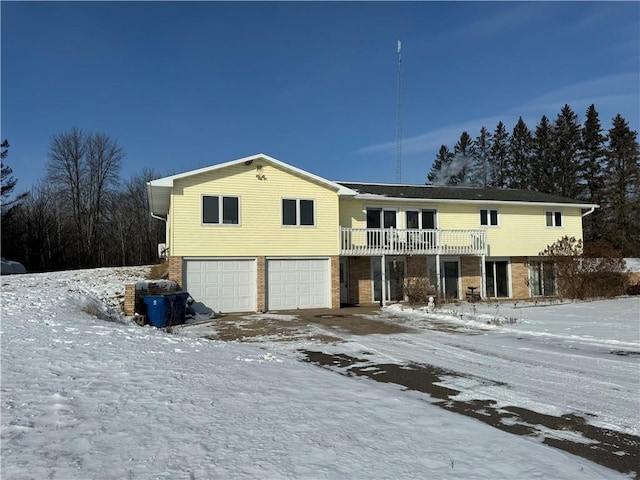 view of front of property featuring a garage and a balcony