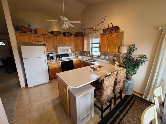 kitchen featuring lofted ceiling, ceiling fan, sink, white appliances, and light tile patterned flooring