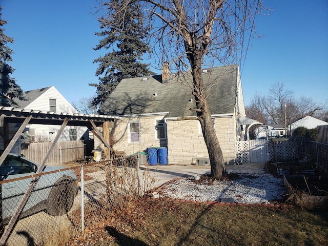 view of property exterior featuring a pergola and a patio area