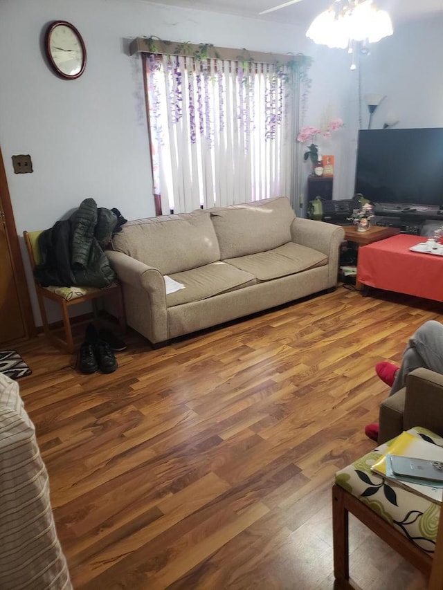 living room featuring ceiling fan and wood-type flooring