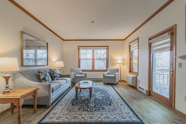 living room with light hardwood / wood-style floors, a baseboard heating unit, and crown molding