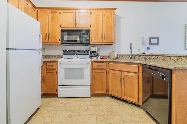 kitchen with sink, light stone counters, and black appliances