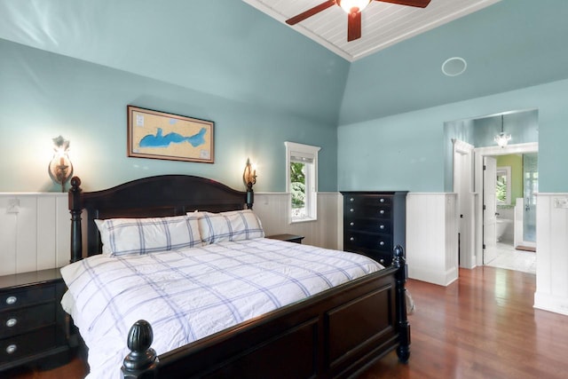 bedroom with lofted ceiling, ceiling fan, connected bathroom, and wood-type flooring