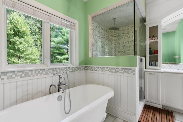 bathroom featuring shower with separate bathtub and vanity