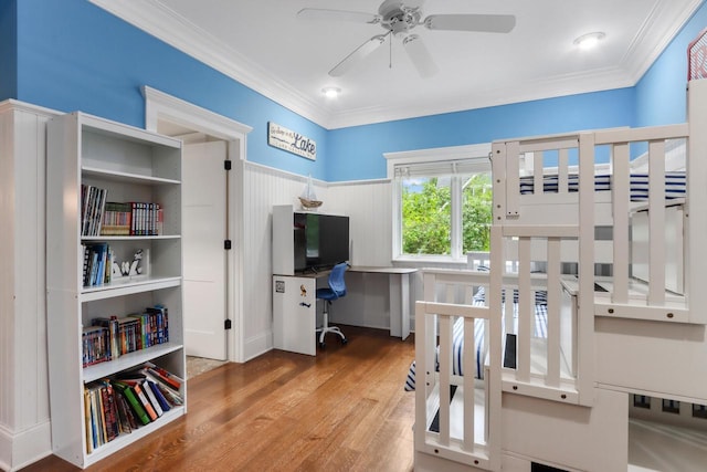 bedroom featuring ceiling fan, crown molding, and hardwood / wood-style floors