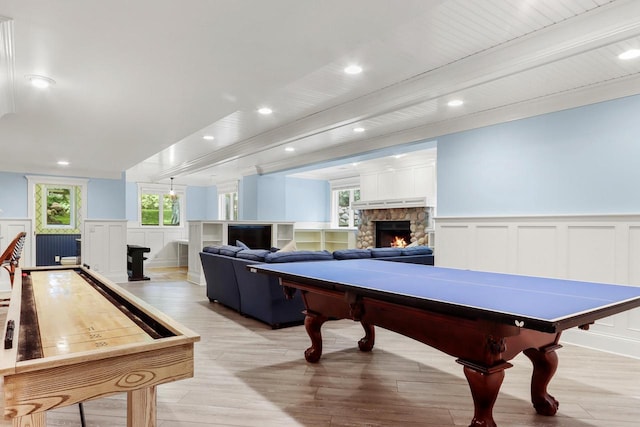 rec room with light hardwood / wood-style flooring and a fireplace