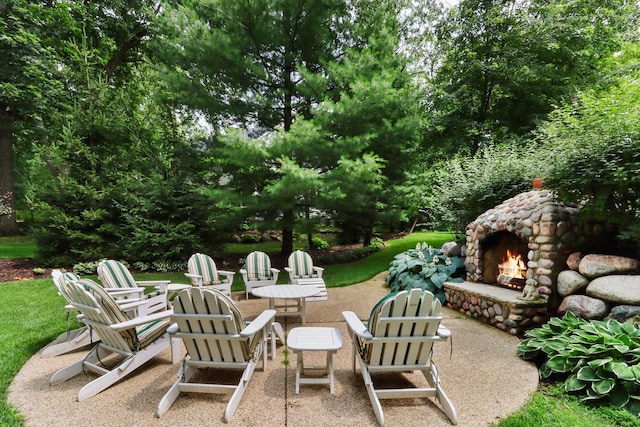 view of patio with an outdoor stone fireplace