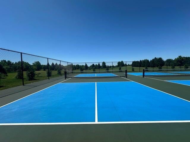 view of tennis court featuring basketball court