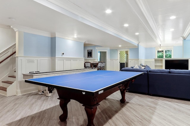 game room with light hardwood / wood-style floors and ornamental molding