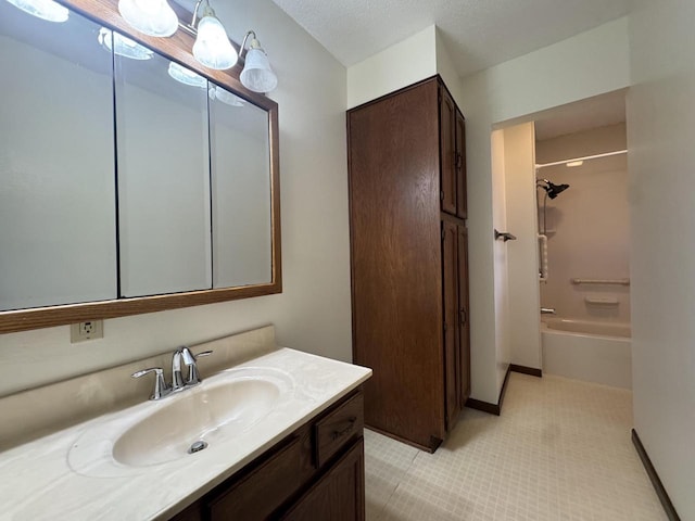 bathroom featuring shower / bathtub combination, a textured ceiling, and vanity