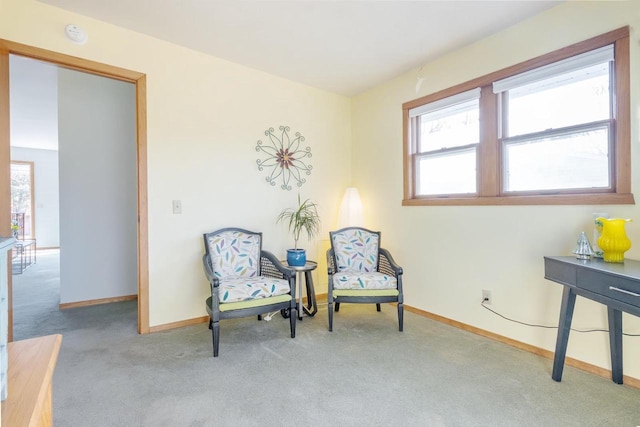 sitting room featuring light colored carpet