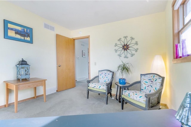 sitting room featuring light colored carpet