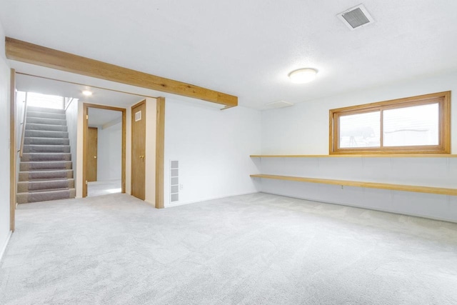 basement featuring light carpet