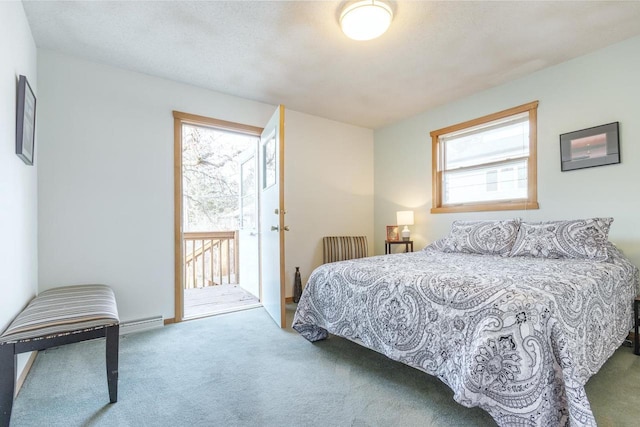 carpeted bedroom featuring access to outside and a textured ceiling