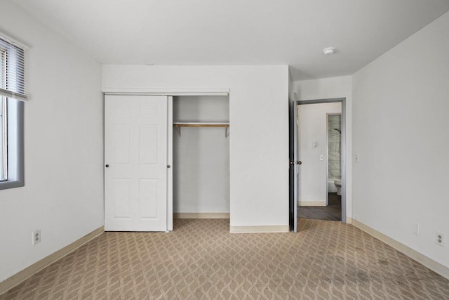 unfurnished bedroom featuring a closet and carpet floors