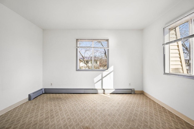 carpeted spare room with baseboard heating