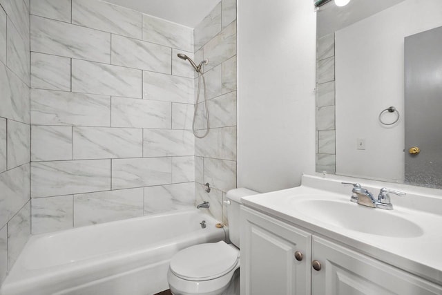 full bathroom featuring toilet, tiled shower / bath, and vanity