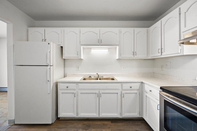 kitchen featuring stainless steel range with electric stovetop, white cabinetry, a baseboard radiator, white refrigerator, and sink