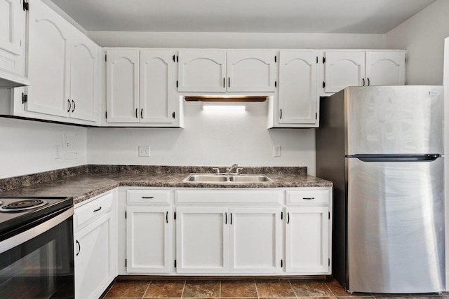 kitchen featuring white cabinetry, black electric range oven, stainless steel fridge, and sink