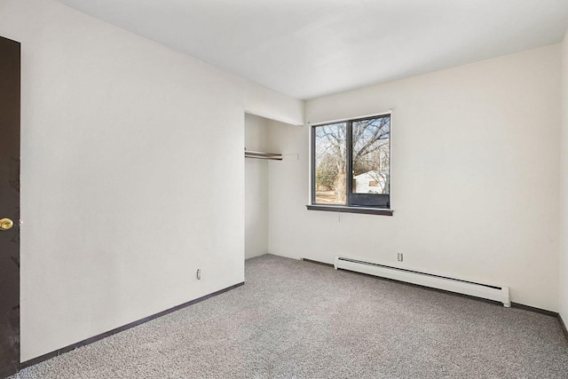 empty room with carpet flooring and a baseboard radiator