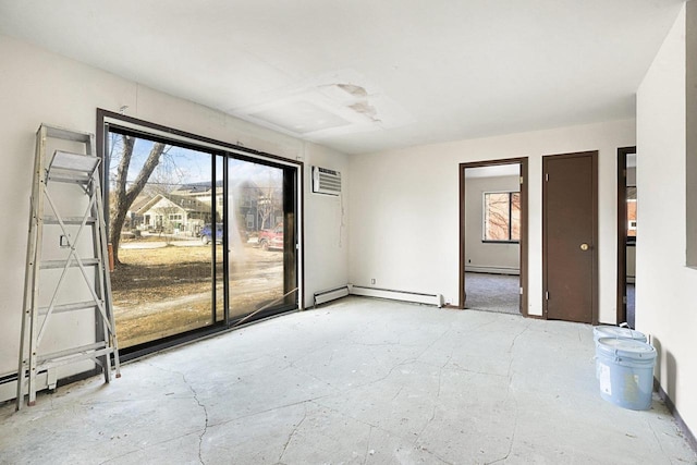 empty room with an AC wall unit and a baseboard radiator