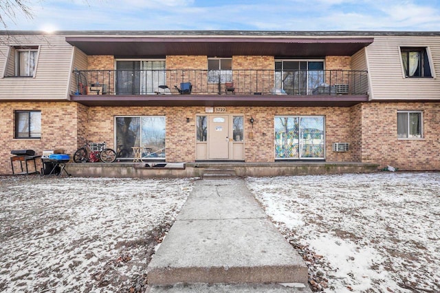 snow covered property featuring a balcony