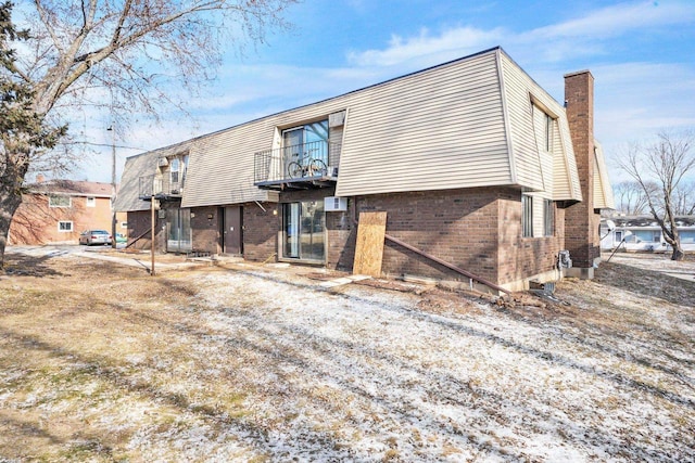 rear view of property with a balcony