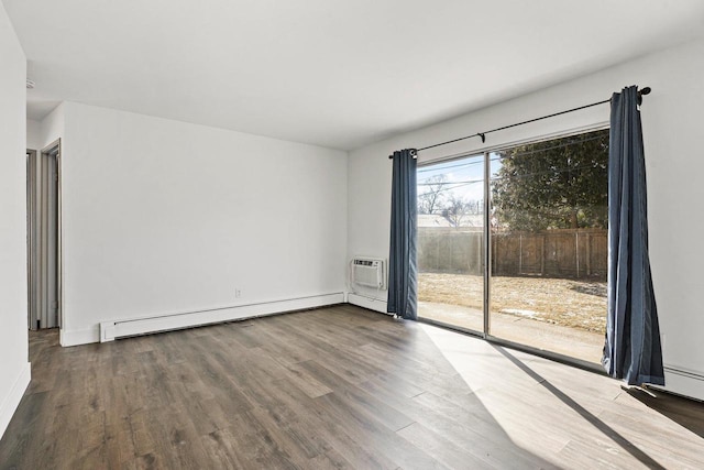 spare room with baseboard heating and wood-type flooring