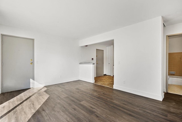 unfurnished room featuring dark hardwood / wood-style floors