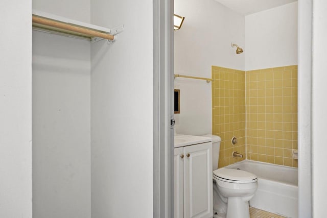 full bathroom featuring toilet, vanity, tiled shower / bath combo, and tile patterned floors