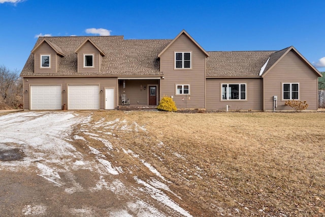 view of front property featuring a front yard and a garage