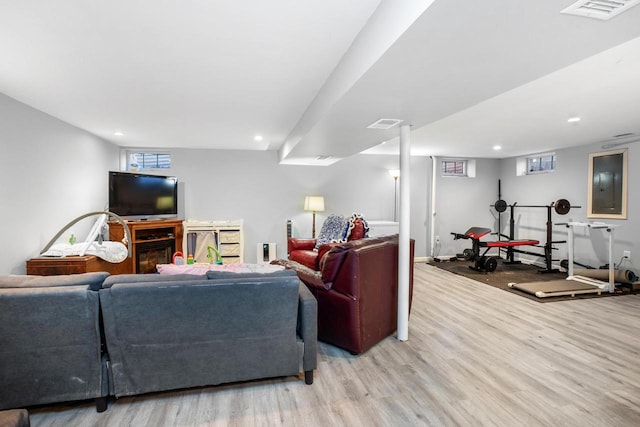 living room with electric panel and light wood-type flooring