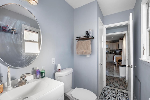 bathroom featuring vanity, tile patterned floors, and toilet