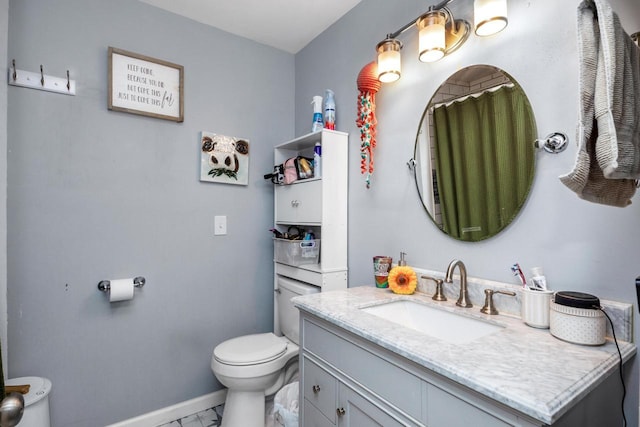 bathroom featuring vanity and toilet