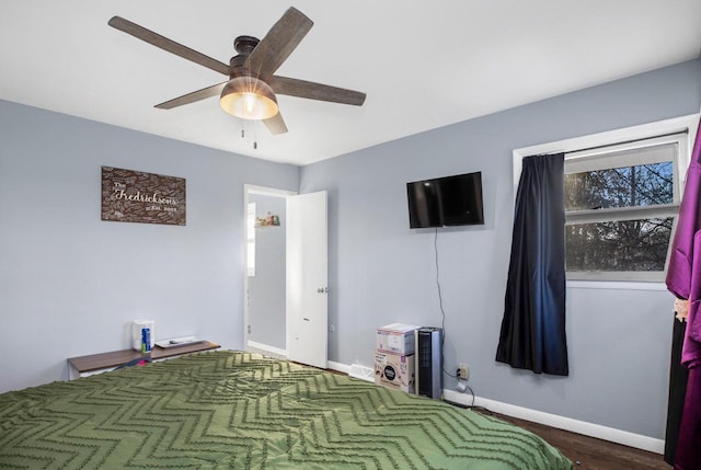 unfurnished bedroom with dark hardwood / wood-style floors and ceiling fan