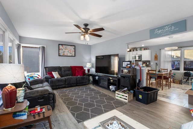 living room with wood-type flooring and ceiling fan