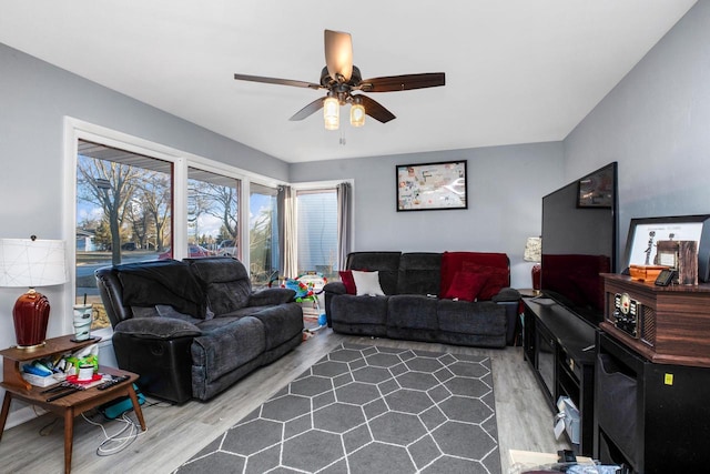 living room featuring wood-type flooring and ceiling fan