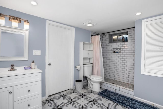 bathroom featuring vanity, tile patterned floors, toilet, and walk in shower