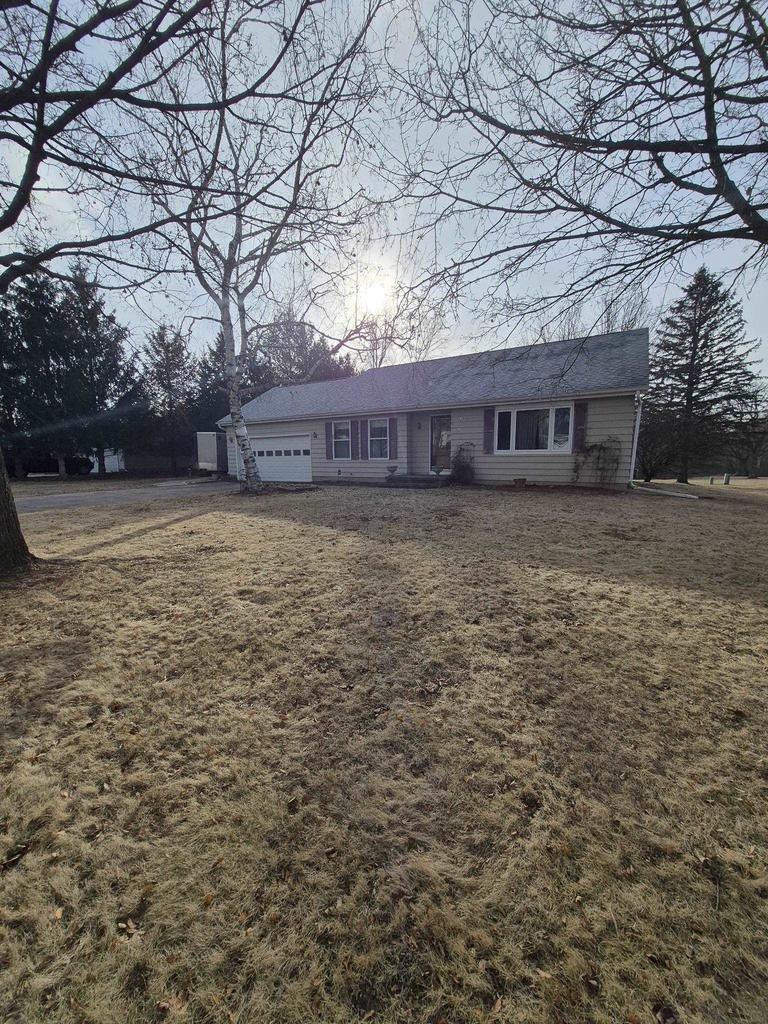 view of front of property with a garage and a front yard