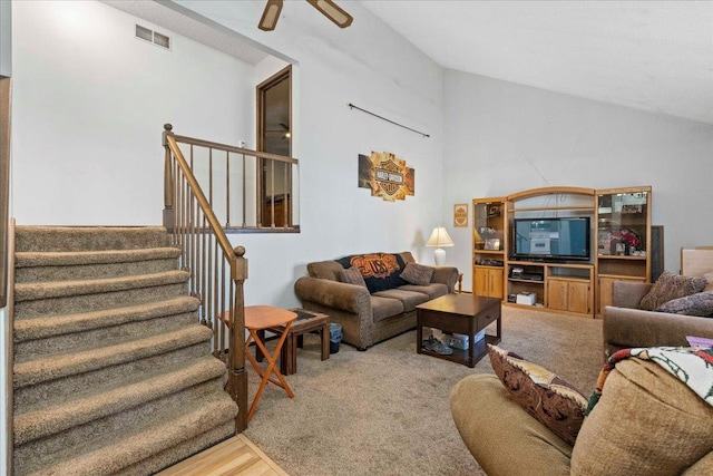 living room with vaulted ceiling, ceiling fan, and carpet