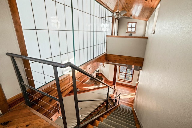 staircase with wood ceiling, lofted ceiling, wood-type flooring, and ceiling fan