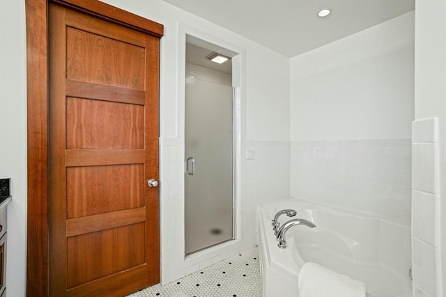 bathroom with vanity, plus walk in shower, and tile patterned flooring