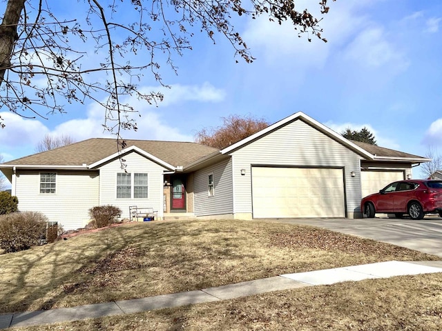 single story home featuring a garage and a front lawn