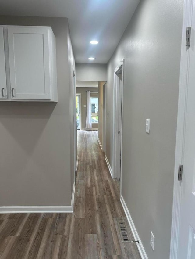 hallway featuring dark hardwood / wood-style flooring