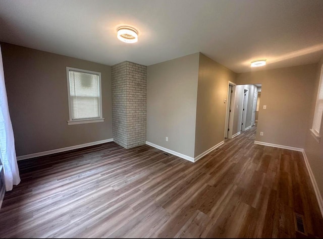 unfurnished room with dark hardwood / wood-style floors