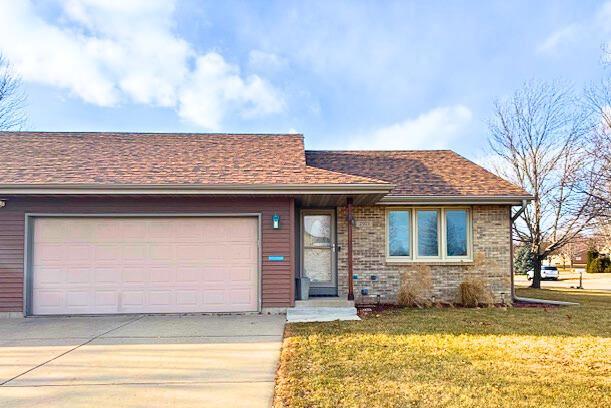 view of front of property featuring a garage and a front yard