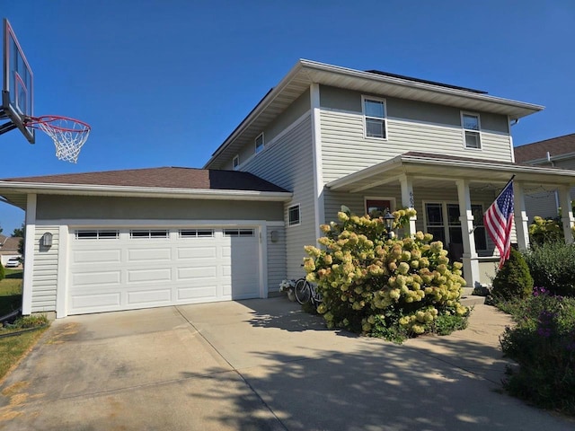 view of front property with a garage and a porch